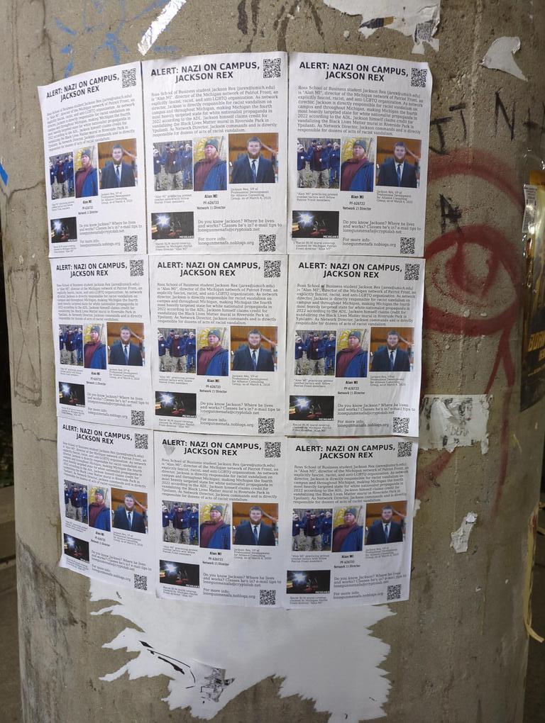 Flyers exposing Patriot Front member "Alan MI" as University of Michigan student Jackson Rex, wheat-pasted in a 3x3 grid on a concrete pillar